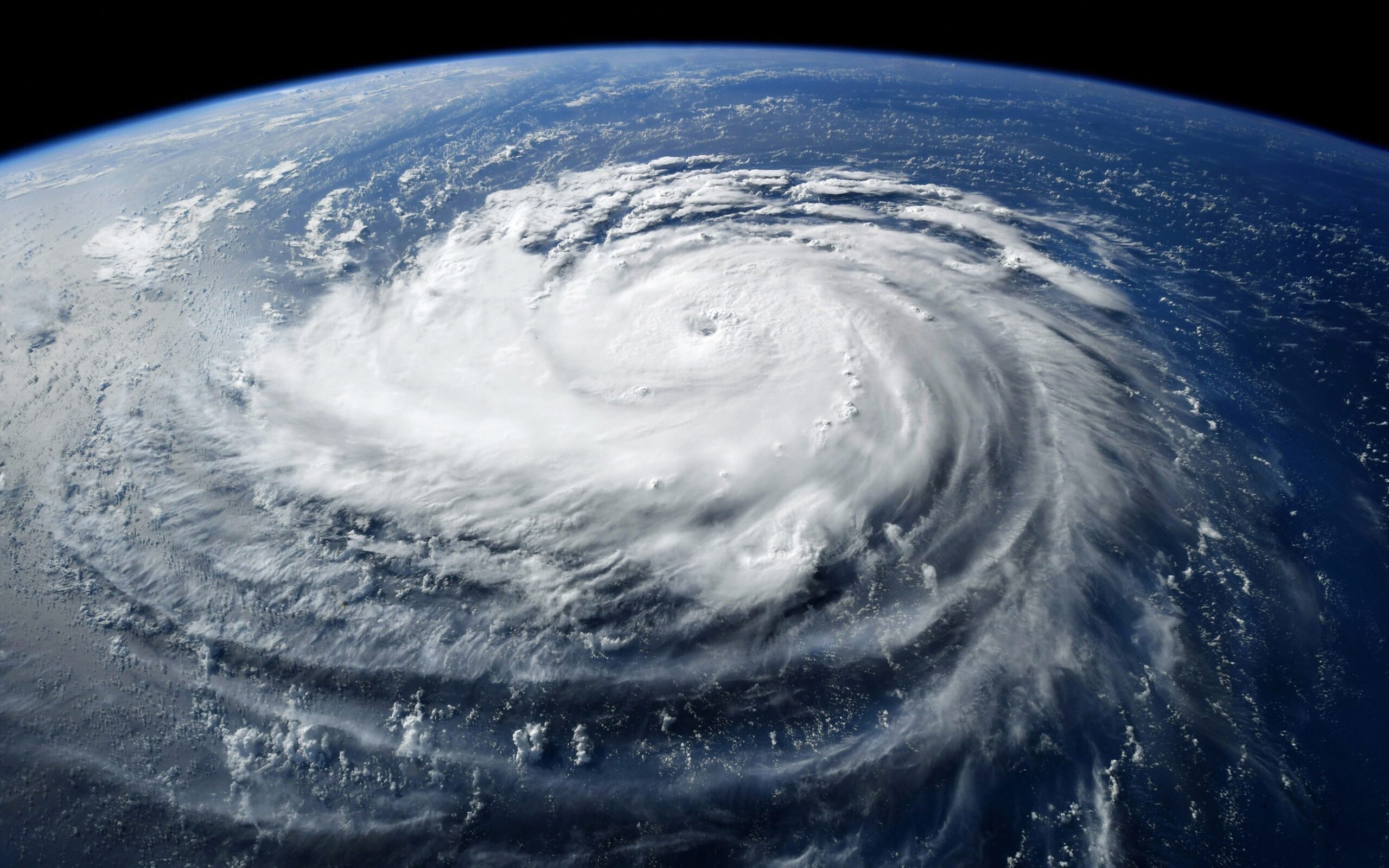 Super,Typhoon,,Tropical,Storm,,Cyclone,,Hurricane,,Tornado,,Over,Ocean.,Weather Tax time with wooden alphabet blocks, red alarm clock, calculator and pen on 1040 tax form background