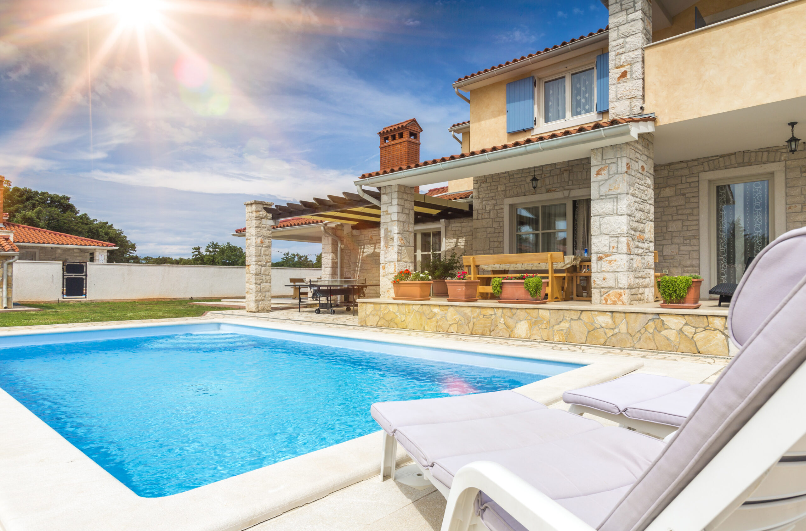 Holiday,House,With,Pool Tax time with wooden alphabet blocks, red alarm clock, calculator and pen on 1040 tax form background
