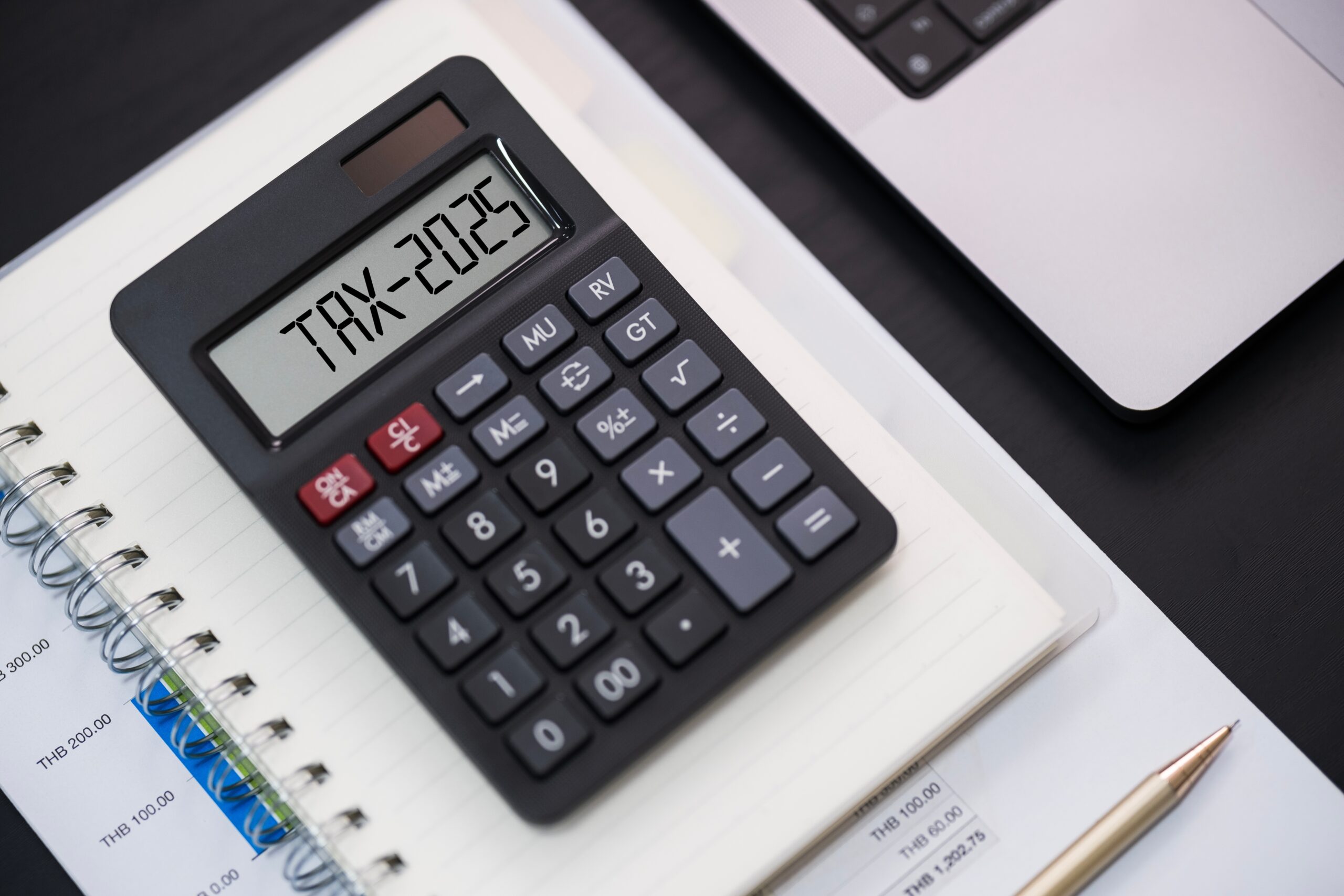 Word,Tax,2025,On,The,Calculator,On,Documents.income,Statement.,Paying Tax time with wooden alphabet blocks, red alarm clock, calculator and pen on 1040 tax form background