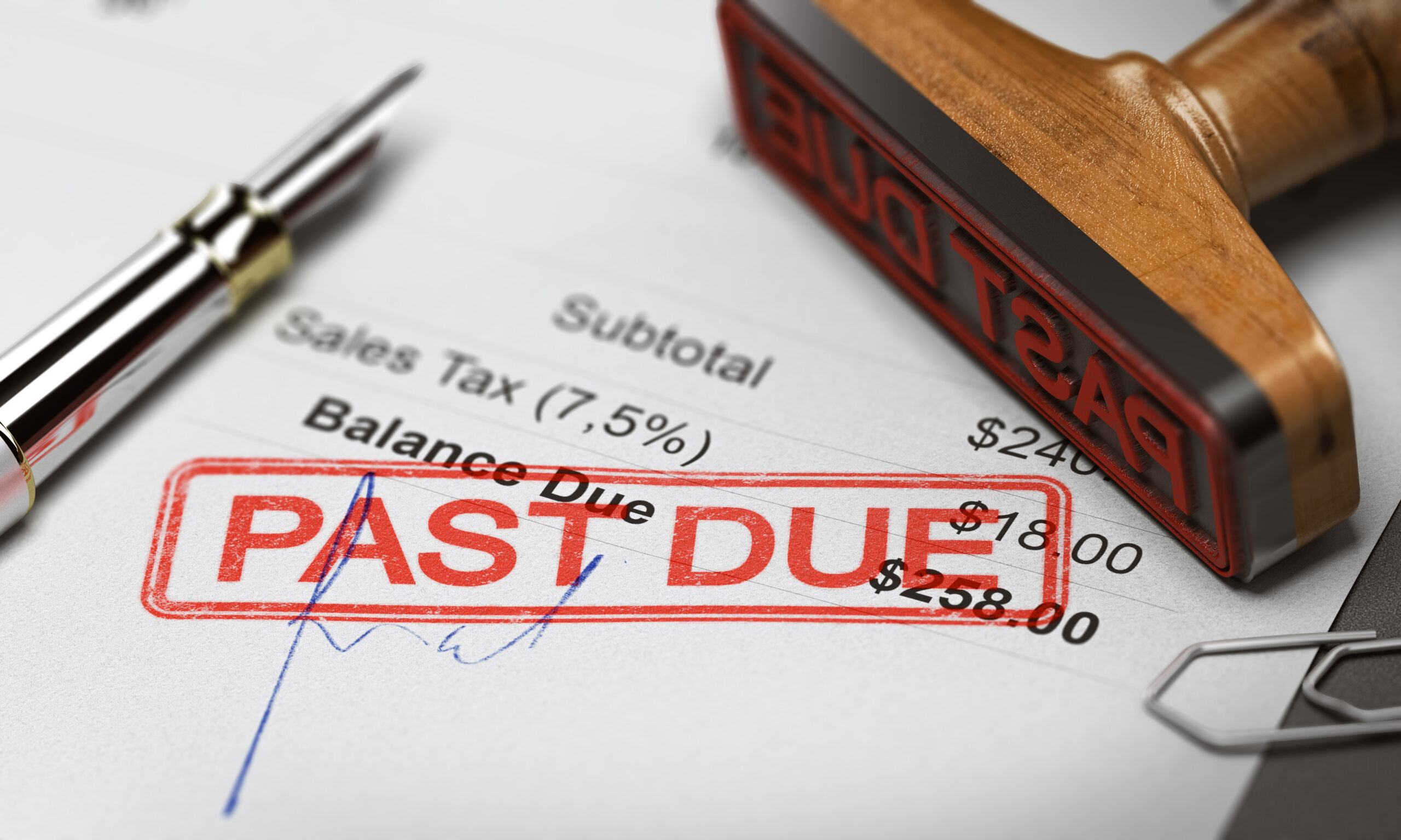 Rubber,Stamp,With,The,Text,Past,Due,Over,An,Invoice Tax time with wooden alphabet blocks, red alarm clock, calculator and pen on 1040 tax form background