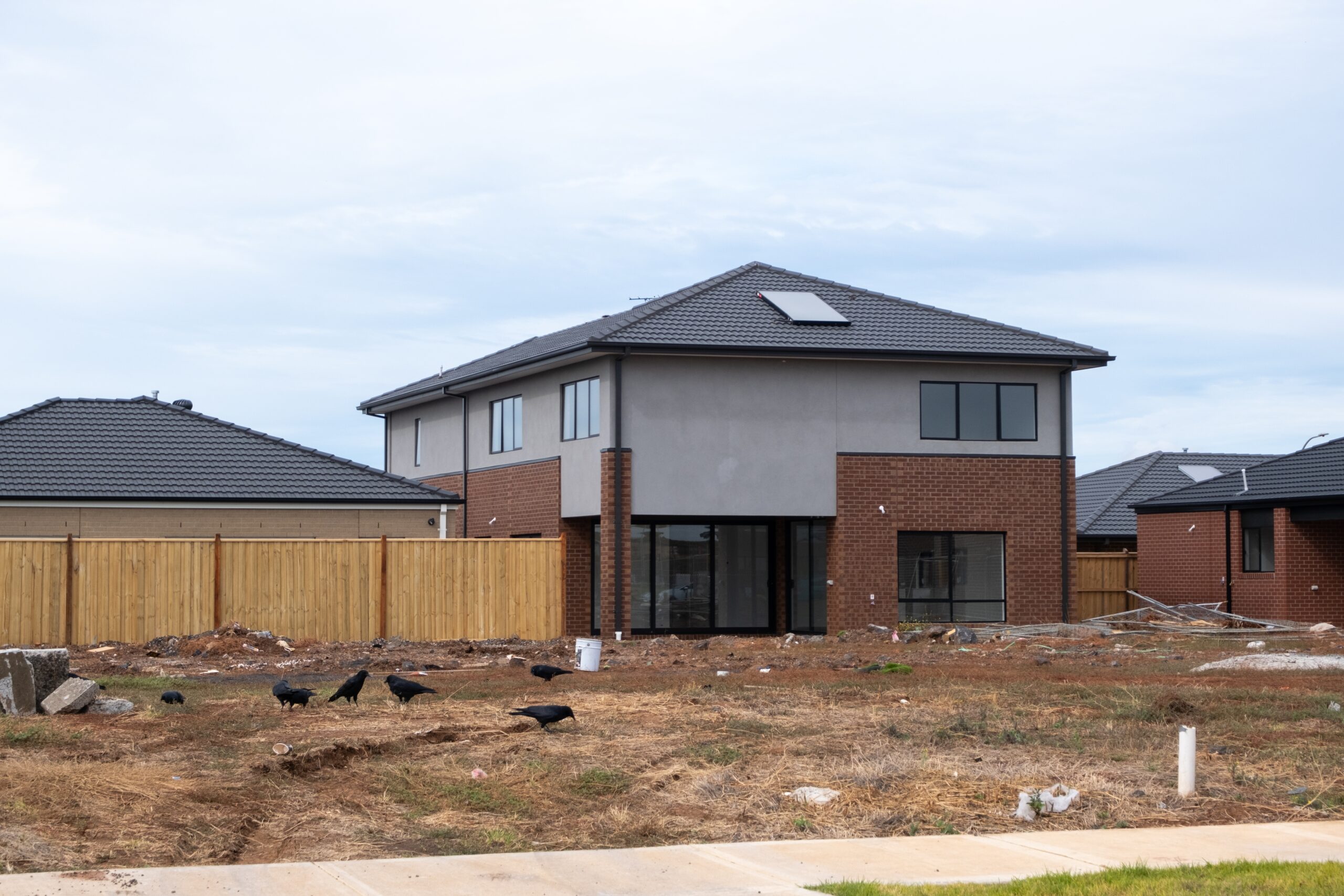 Tax time with wooden alphabet blocks, red alarm clock, calculator and pen on 1040 tax form background