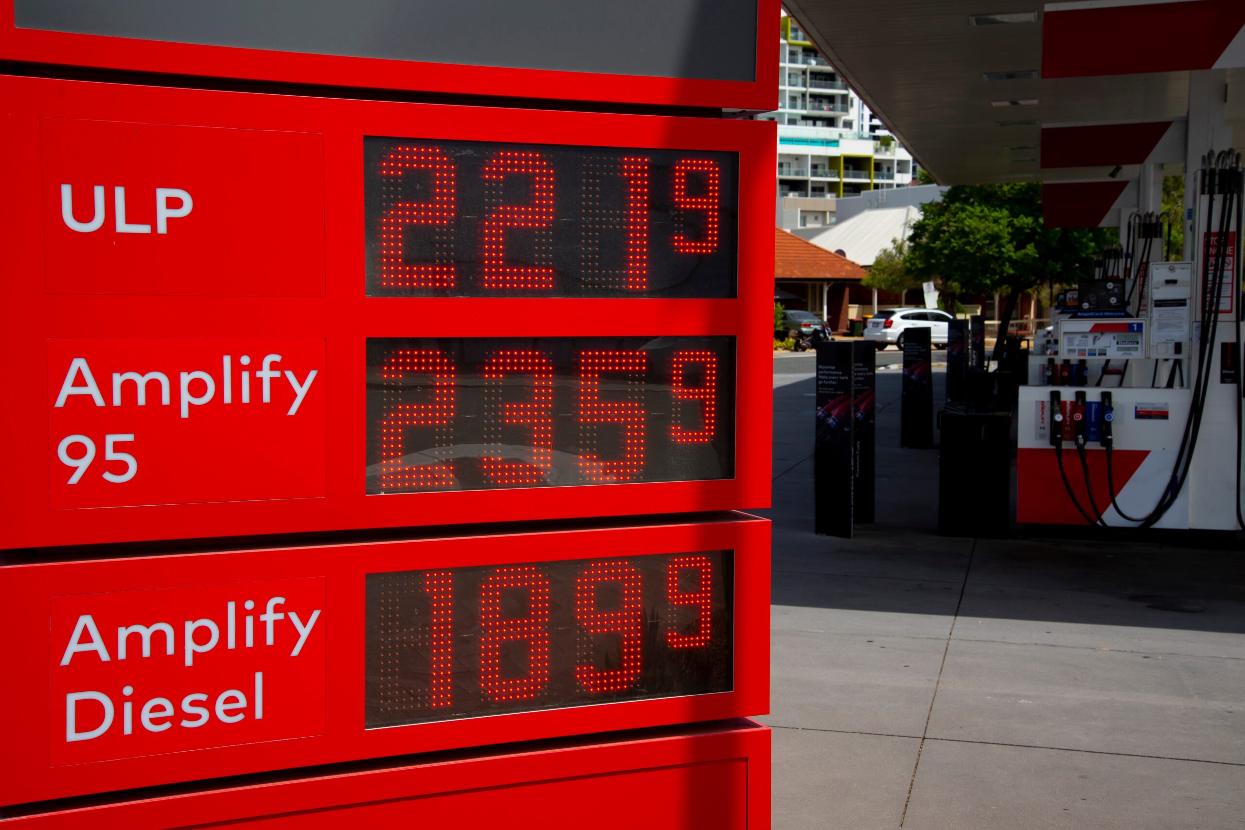 Record,High,Fuel,Prices,In,Gas,Station Tax time with wooden alphabet blocks, red alarm clock, calculator and pen on 1040 tax form background